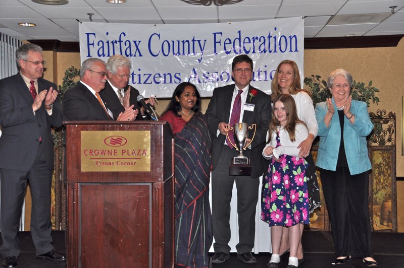 Past Federation President John Jennison, Congressmen Gerry Connolly and Jim Moran, Federation President Tania Hossain, Citizen of the Year Walter Alcorn, his daughter and wife and Past Board Chairman Kate Hanley