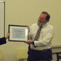 Providence District Chairwoman Denise Rodgers (left) hands C. Flint Webb his Community Service Award as member Becky Cate looks on.